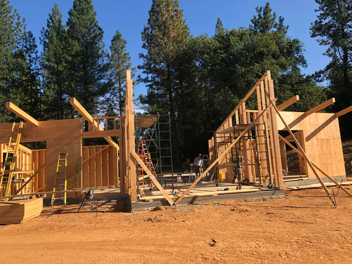 Framed house wings with braced walls and angled roof beams